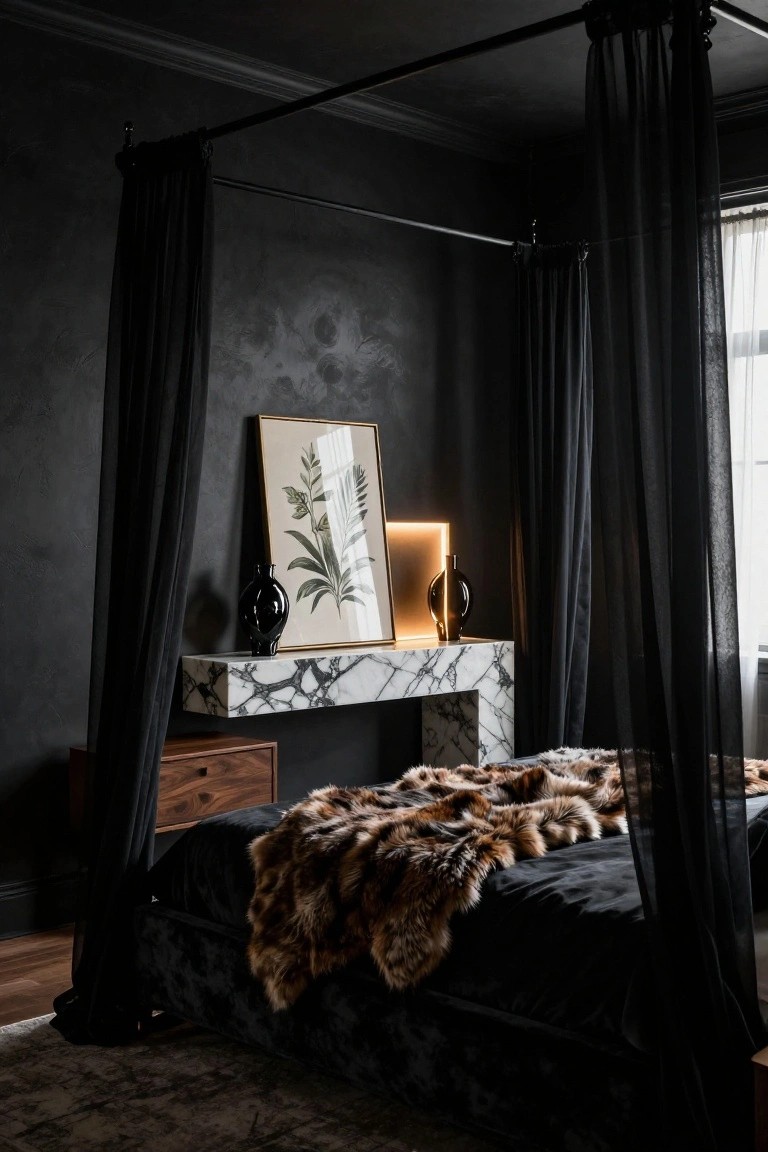 Dark bedroom with black velvet canopy bed draped in sheer black fabric, brown fur throw on bed, white marble floating shelf holding black vases and neon-lit frame with botanical print, textured black walls, wood side table, and hardwood floor.